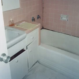 Modern full bathroom remodel in Newport Beach with a freestanding soaking tub, wood-style vanity, and custom tile work by CALbath Renovations.